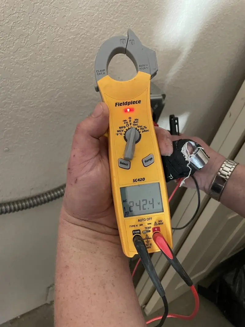 Voltage testing with clamp meter during Electrical Installation Services in Pearsall